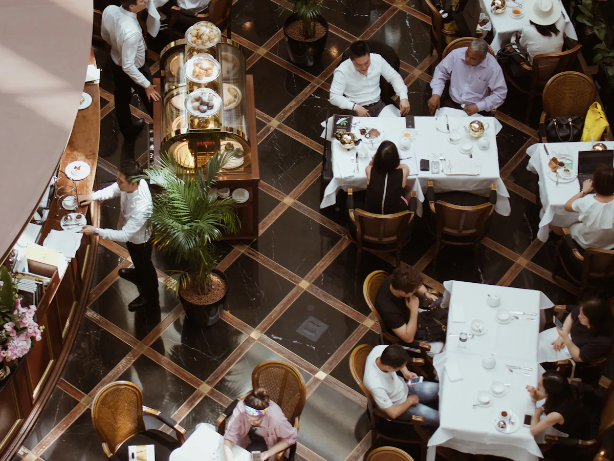 Waiting staff at the pass in a busy five-star dining room
